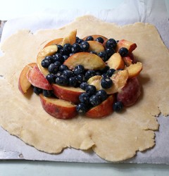 peaches and blueberries, tossed with cornstarch, ready to be folded into pie dough
